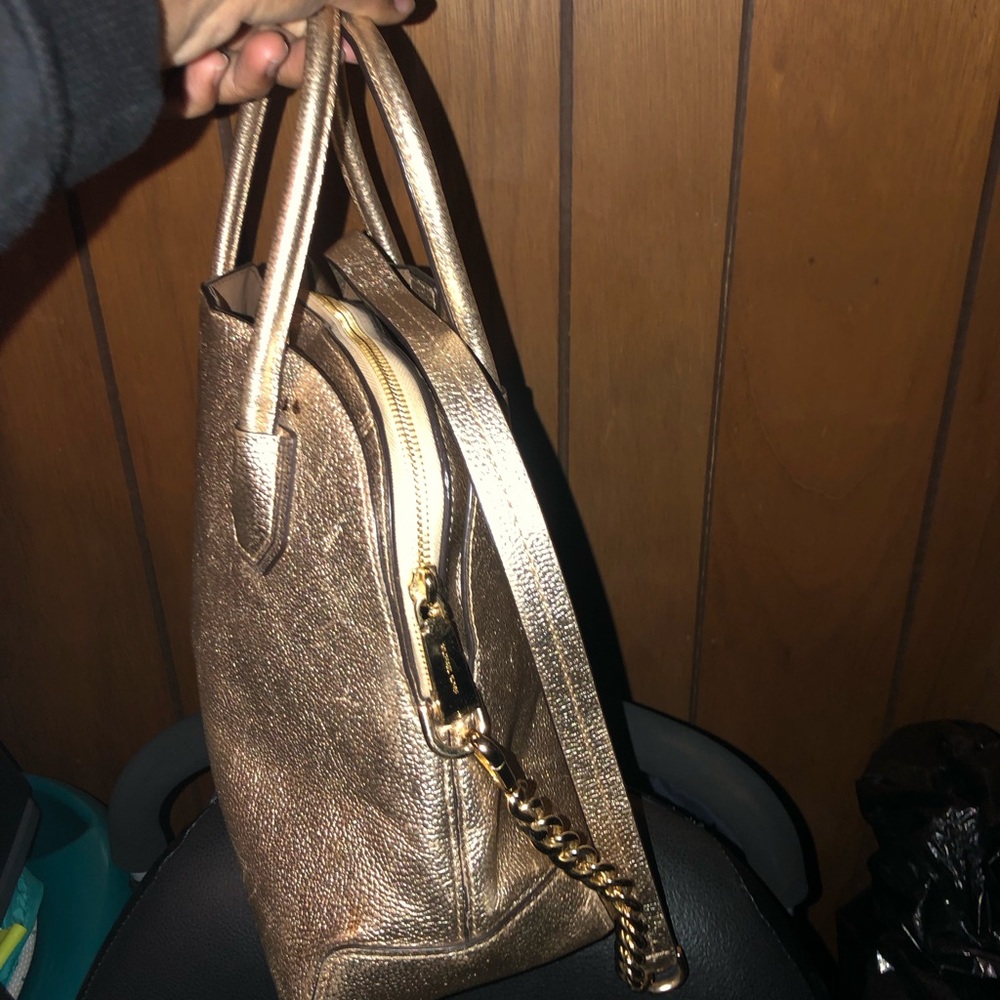 Got a only one time used Gold colored Michael Kira purse